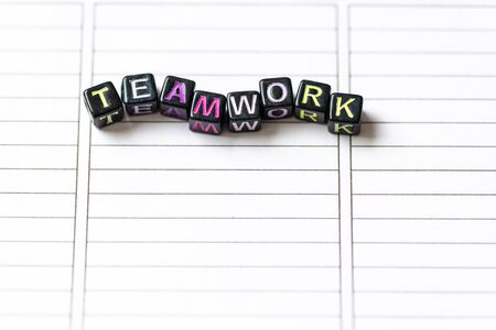 Teamwork word from blocks on clean page notebook close up. Team work concept.の写真素材