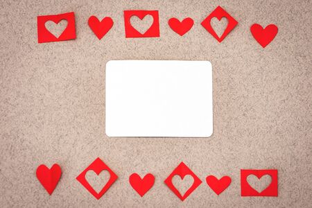 Valentines day hearts border and white blank on greeting card over paper background. Top view with copy spaceの写真素材