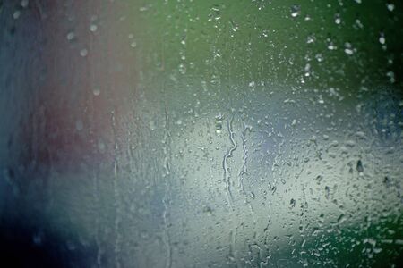 Moisty wet window with water running down the surface. Window glass after heavy rain. Abstract...