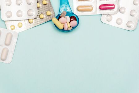 Medicine Pills on on blue backdrop. different color pills of drugs and medicines. Copy space