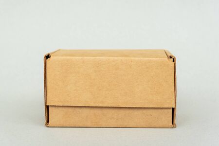 Closed box on white background, copy space. Packaging, online shopping and delivery of goods from...