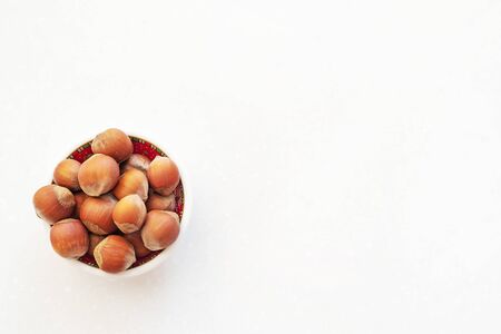Healthy snack nuts. Top view of bowl with hazelnuts on table. Healthy food concept.の写真素材