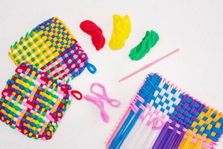 childrens creativity weaving with colored threads ropes. Child hands in workの写真素材