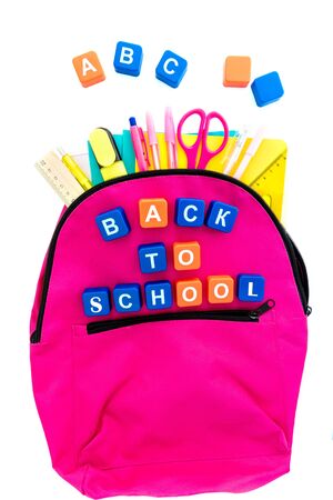 Back to school concept. Pink backpack with school supplies on white. Caption: back to school. Top view. Copy spaceの写真素材