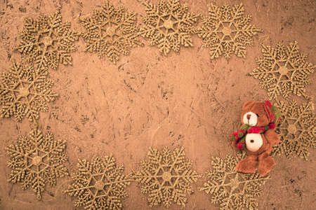 Frame made of decorative golden snowflakes on a golden textured background. Christmas pattern blank. Flat lay, copy space.の写真素材