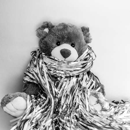 Christmas composition with stuffed toy teddy bear. Black and white square photoの写真素材