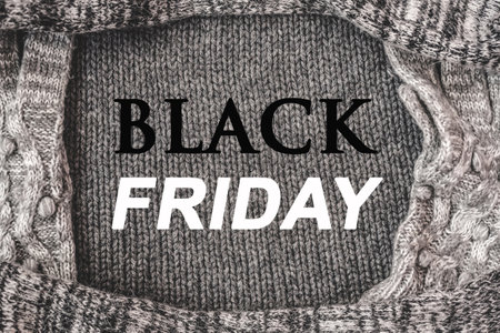Flat lay with words BLACK FRIDAY on gray frame texture knitted background. Top view big sale concept. Warm winter collectionの写真素材