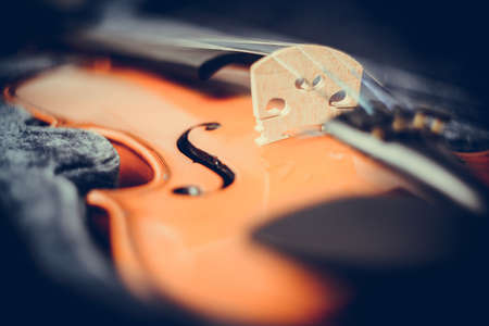 Close up brown wooden violin lying in the case. Traditional music instrument.の写真素材