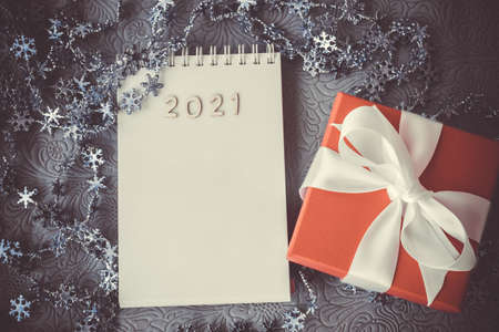 Christmas gift on red box and white bow Notepad with 2021 and copyspaceの写真素材