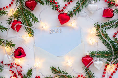 Frame made of branches of a Christmas tree and glass decorations in the shape of hearts.の写真素材