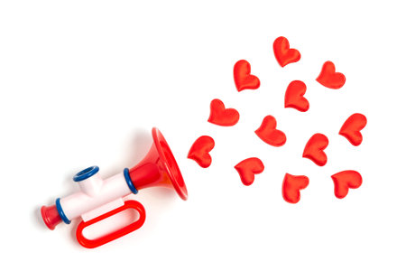 Red hearts fly out of the childrens toy pipe. The concept of a Valentines Day love song for sweetheart.の写真素材