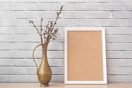 Vase with pussywillow and empty frameの写真素材