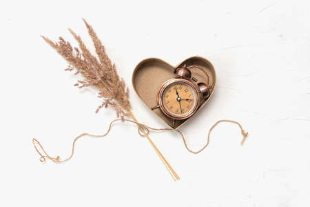 Gift cardboard heart box with antique watchの写真素材