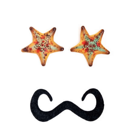 Male anthropomorphic face, with starfish eyes and black mustache