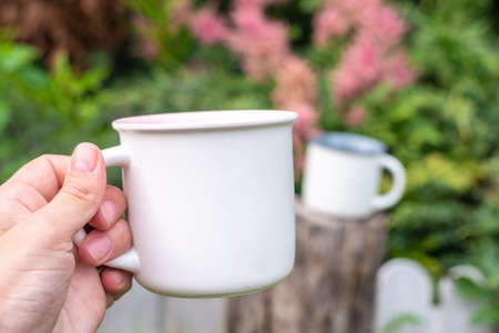 Mug mockup with bokeh green nature.の写真素材