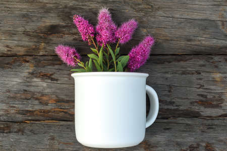 Mug mockup and flowers flat lay on woodenの写真素材