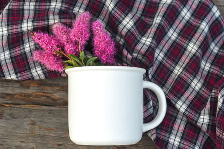 Mug mockup and flowers flat lay on woodenの写真素材