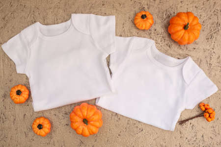 White baby bodysuit mockup on golden wooden