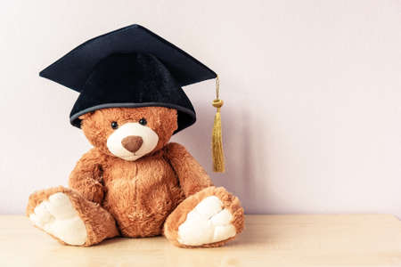 Adorable teddy bear sits on wooden table, copy spaceの写真素材