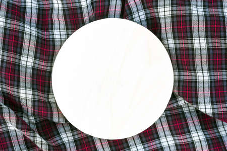 Round wood sign with template for design on checkered fabricの写真素材