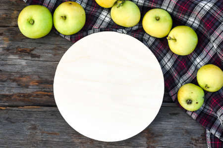 Wood round sign and delicious juicy green applesの写真素材