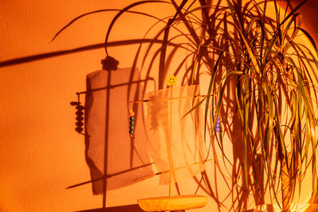 Directed spotlight beam illuminates plant against grey wall