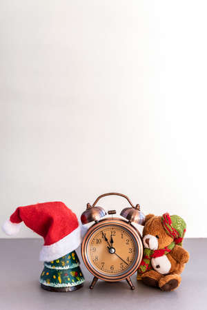 Christmas composition of teddy bear and alarm clock on tableの写真素材