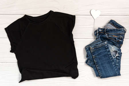 Black t shirt mockup on whte wooden background.