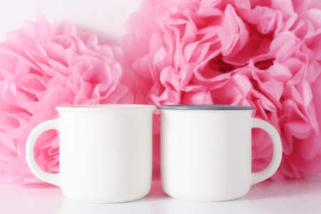 White mockup mug on a pink paper flowers background.の写真素材