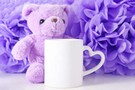 White mockup mug on a pink paper flowers background.の写真素材