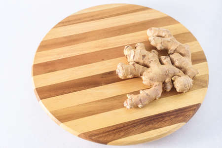 Fresh ginger root on wooden board