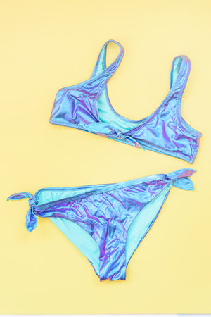 Blue swimsuit on yellow backgroundの写真素材