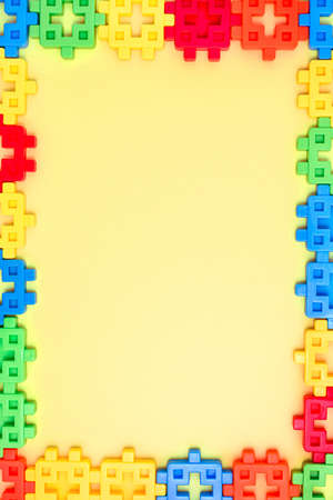 Colorful kids toys frame on yellow background.の写真素材