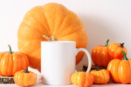 Mug with pupkins fall mockup.. White coffee cup mock up. Blank mug printing design template. Autumn, halloween and thanksgiving conceptの写真素材