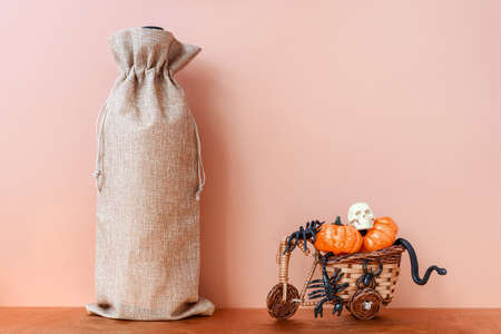 Halloween mockup with wine bag blank with pupkin and spiders. Wine bag mock up horror decoration. Fall holiday mock up.の写真素材