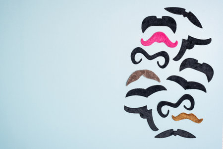 Border, frame make of different fake mustaches on blue background, copy spaceの写真素材