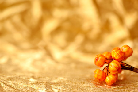 Golden background fall in abstract style with orange pumpkin decoration.の写真素材