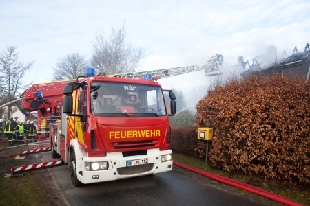Firefighters turntable ledder at house fireのeditorial素材