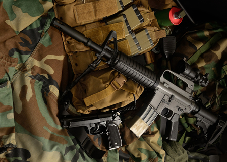 Assault rifle 5.56mm m16 Colt carbine with tactical chest rigs. Military Equipment.の写真素材