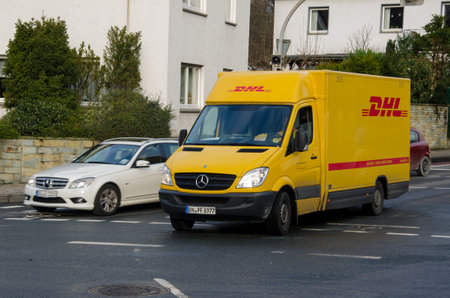 Soest, Germany - December 20, 2017:  DHL car drives on a street. DHL is the global market leader in the logistics industry.のeditorial素材