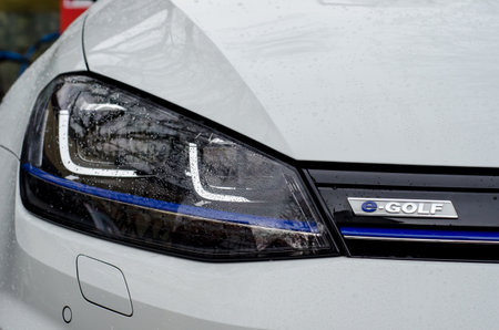 Soest, Germany - December 23, 2017: Close-up - the front of the white Volkswagen e-Golf car with the company logo.のeditorial素材