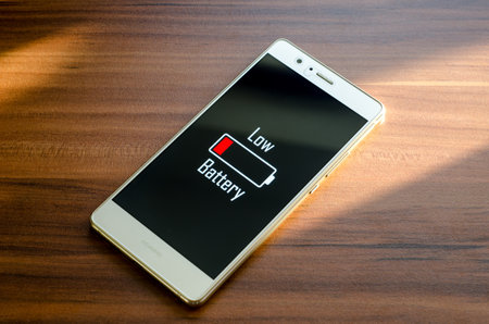 Soest, Germany - January 13, 2018: Inscription Low Battery on screen of Huawei P9 lite.のeditorial素材