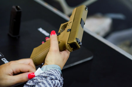 Kyiv, Ukraine - October 10, 2018: glock pistol in girl hand. International Exhibition ARMS AND SECURITY 2018のeditorial素材