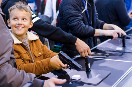 Kyiv, Ukraine - October 10, 2018: child with a gun. International Exhibition ARMS AND SECURITY 2018のeditorial素材