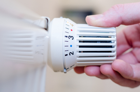 Close Up Of Hand Adjusting Heating .の写真素材