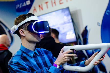 Kyiv, Ukraine - April 12, 2019: Man playing PlayStation VR with Aim Controller.