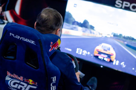 Kyiv, Ukraine - April 12, 2019: Man playing car video games sitting on a Playseat.のeditorial素材
