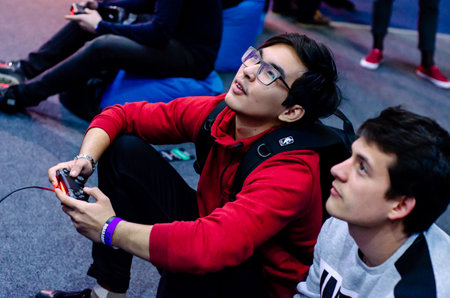 Kyiv, Ukraine - April 12, 2019: The guys are playing a video game on ps4.のeditorial素材