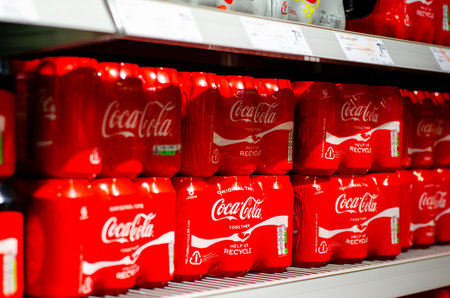 Vianden, Luxembourg - July 27, 2019:  Coca-cola in bottles on row display for sale in the store.のeditorial素材