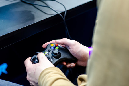Kyiv, Ukraine - April 12, 2019: Close-up of gamepad Xbox in hand.